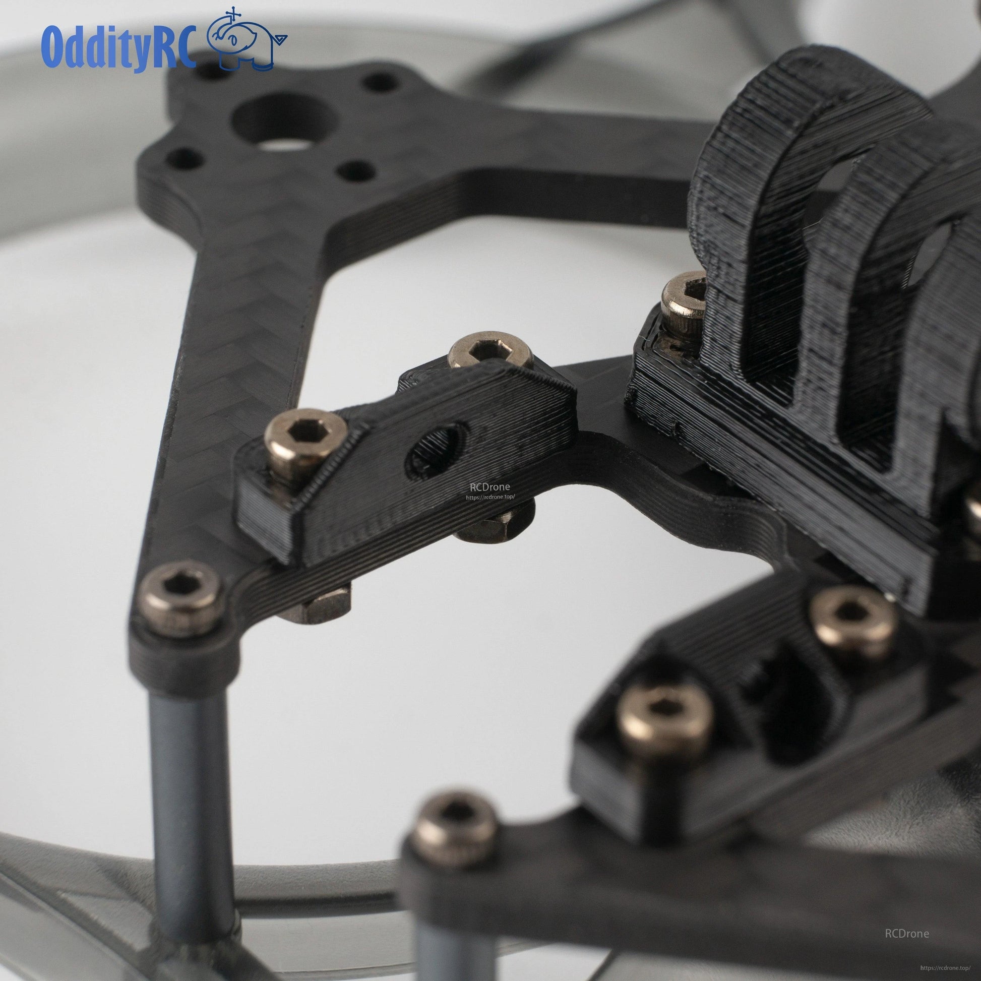 Close-up of top plate mounting bracket and screw hardware on OddityRC frame