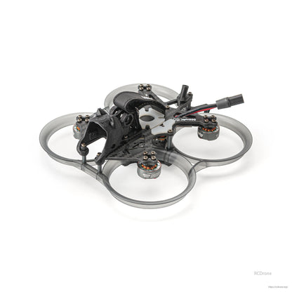 Three-quarter view emphasizing translucent prop ducts, four motors, and top battery strap on cinewhoop frame