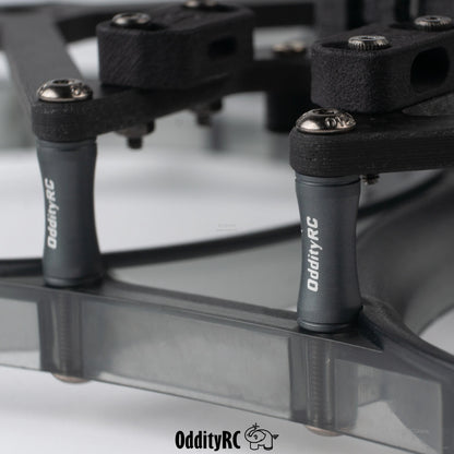 Close-up of OddityRC standoffs and hardware on smoke gray prop guard ring