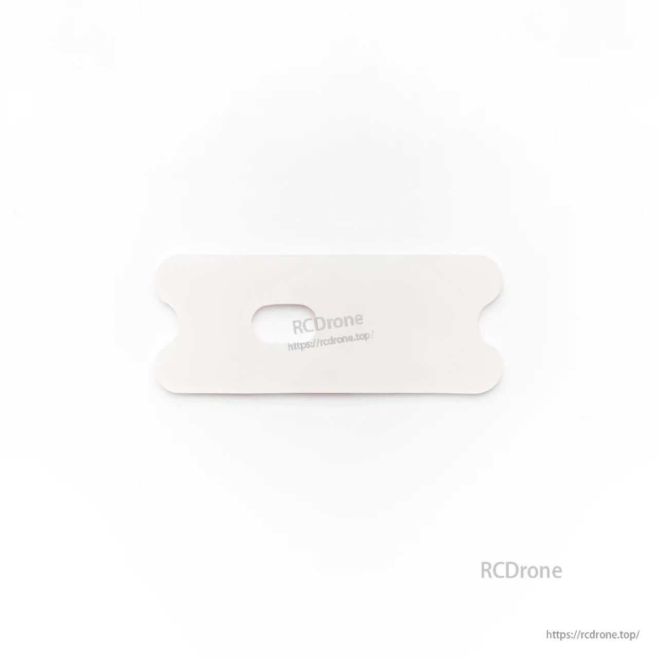 White rectangular battery pad/plate with center slot for strap, top view