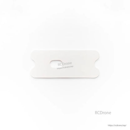 White rectangular battery pad/plate with center slot for strap, top view