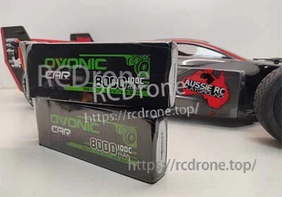Ovonic 100C 11.1V 8000mAh 3S LiPo battery pack displayed beside an RC car body