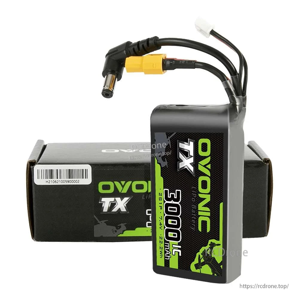 Ovonic TX 3000mAh 2S LiPo battery standing next to retail box, showing attached XT60 and DC barrel connector