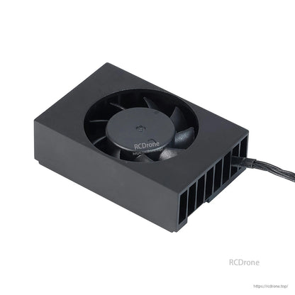 Angled top view close-up of fan and finned heatsink housing with attached cable