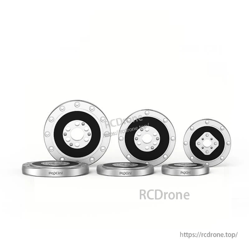 Three round sensor faces in different sizes with matching base rings laid in front, lineup on white background