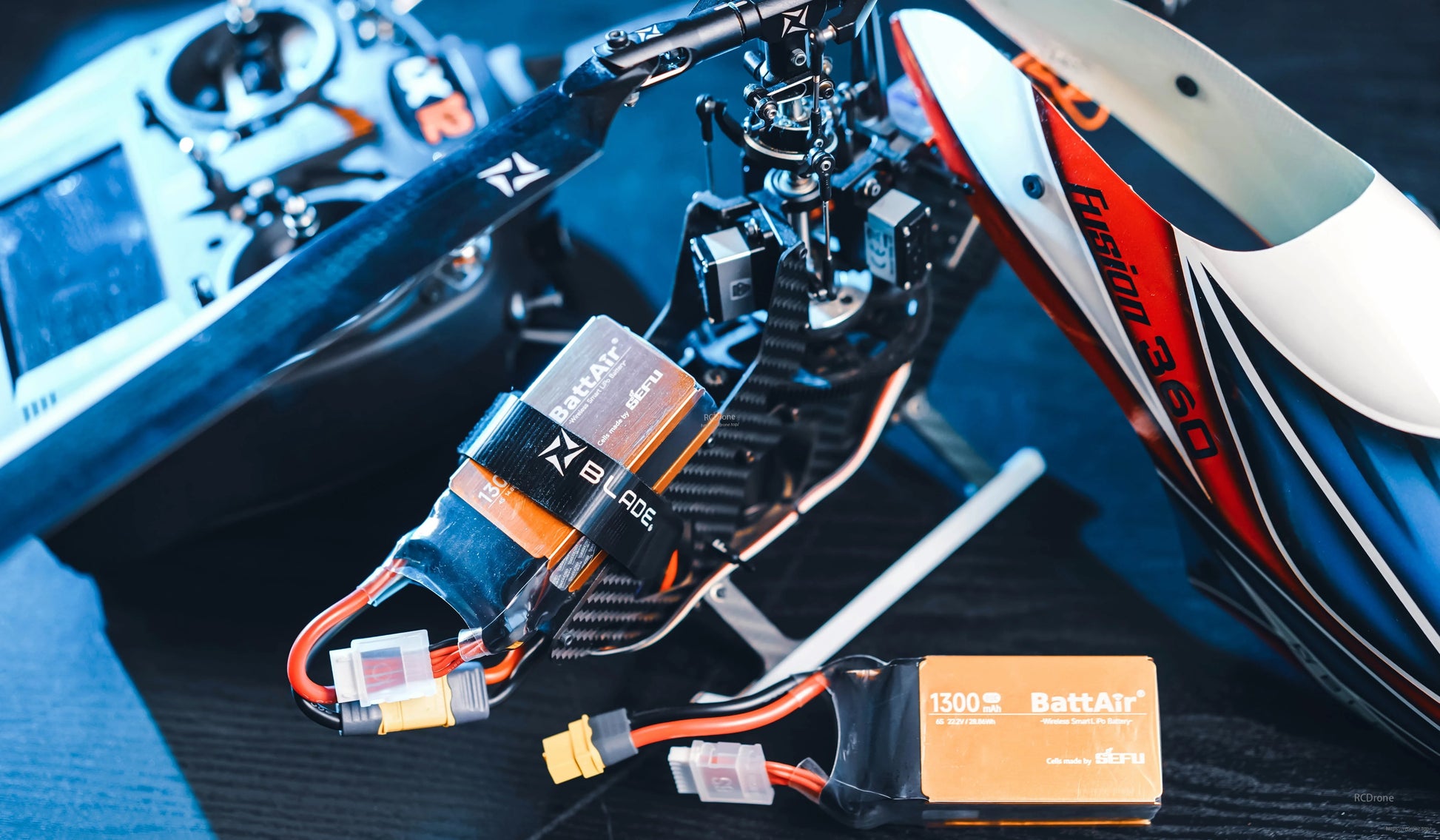 RC LiPo battery pack (BattAir 1300mAh) with XT60-style power plug and balance lead mounted on an RC helicopter