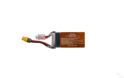 RC LiPo battery pack with yellow XT60 connector and white balance plug, wrapped in black heat shrink with warning label
