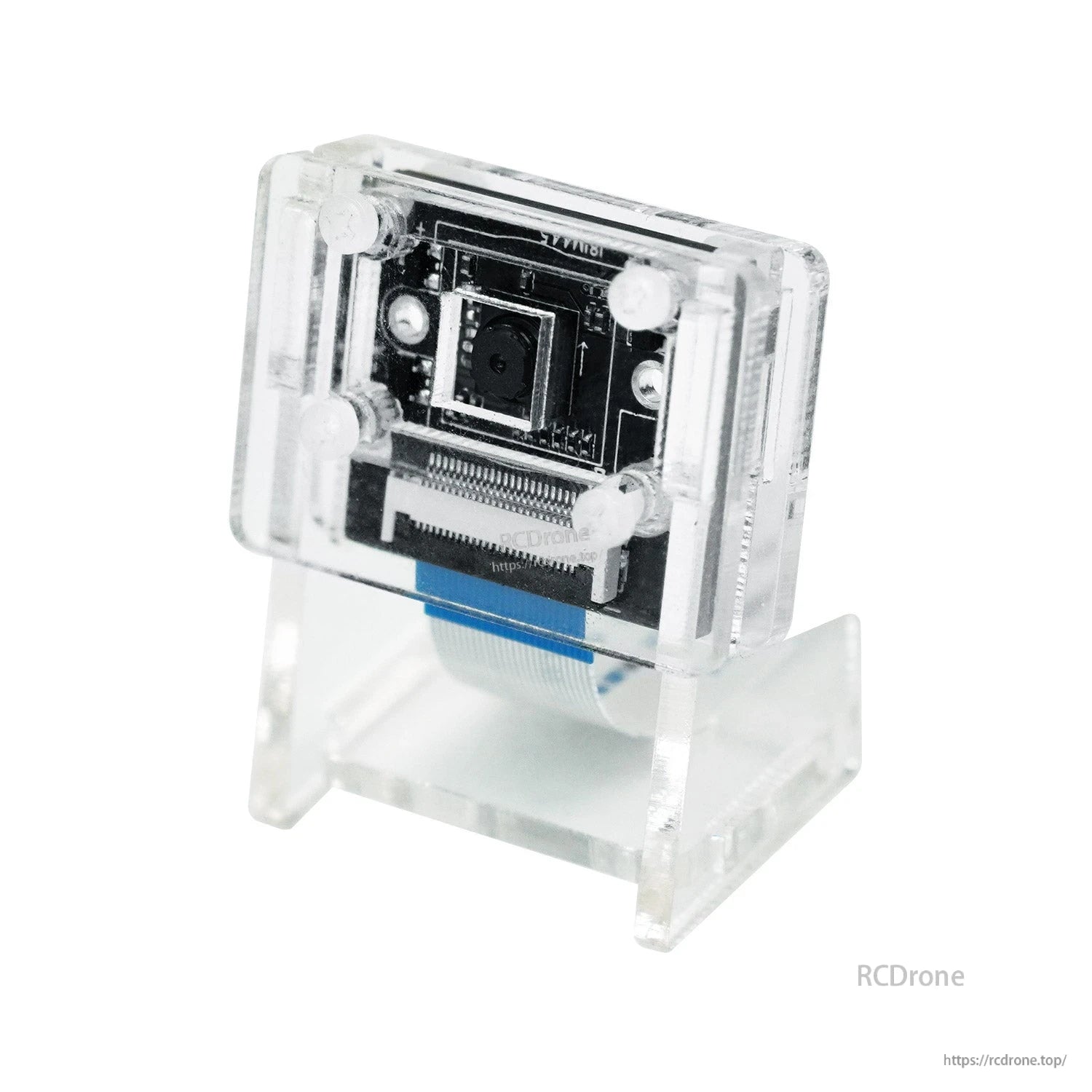 Camera module installed in clear acrylic protective bracket and stand, angled view with ribbon cable