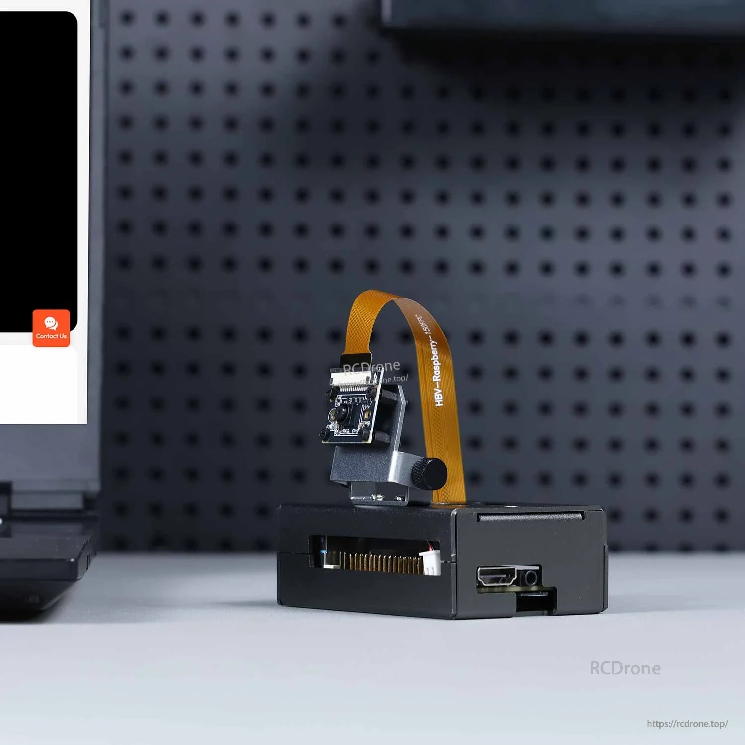 RDK X5 case shown in use with mounted camera bracket and ribbon cable; HDMI and side openings visible