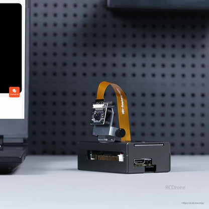 RDK X5 case shown in use with mounted camera bracket and ribbon cable; HDMI and side openings visible