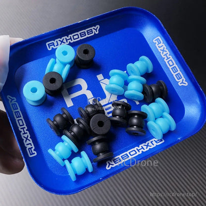 Blue and black silicone anti-vibration damping balls with center holes in an RJXHOBBY tray