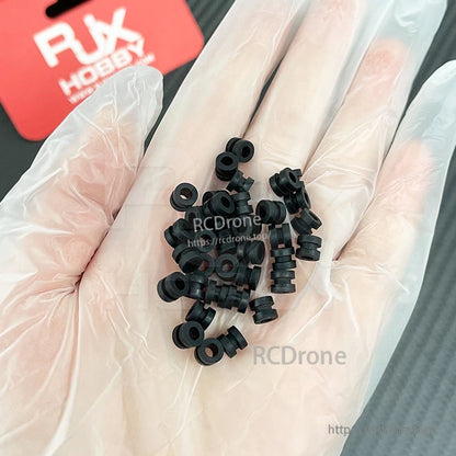 RJX 100pcs 3x5x6mm Damping Ball, Hand holding small black rubber damping balls/grommets for RC builds, RJX 3x5x6mm size