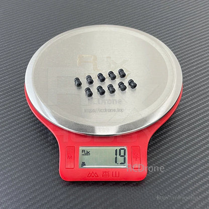 RJX 100pcs Damping Ball, Small black rubber damping balls on a digital scale, showing 1.9 g for the sample set
