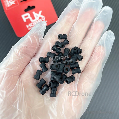 RJX 100pcs Damping Ball, Hand holding small black rubber damping balls for RJX RC helicopter parts, with RJX packaging in background