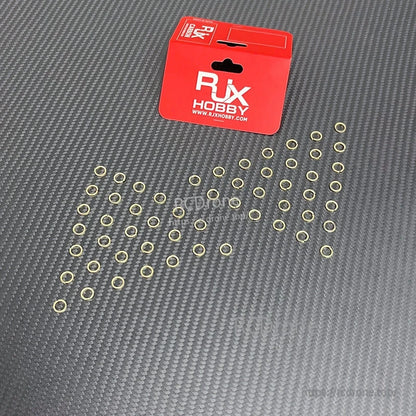 RJX Hobby SMA connector tooth lock washers and nut gaskets spread out on a carbon fiber surface