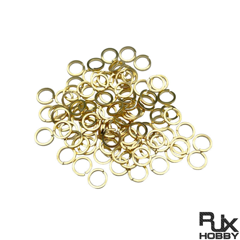 Pile of gold-toned tooth lock washers and gaskets for SMA female connector nuts