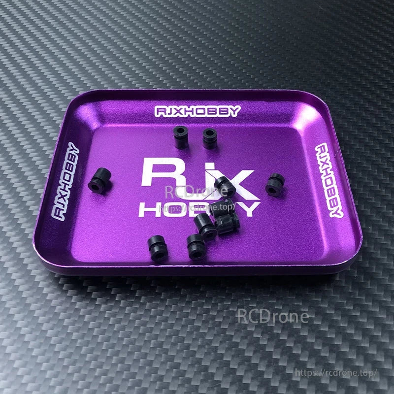 RJX 100pcs Silicone Anti‑Vibration Damping Ball, RJX silicone anti-vibration damping balls in black, small cylindrical mount dampers on a purple RJXHOBBY tray