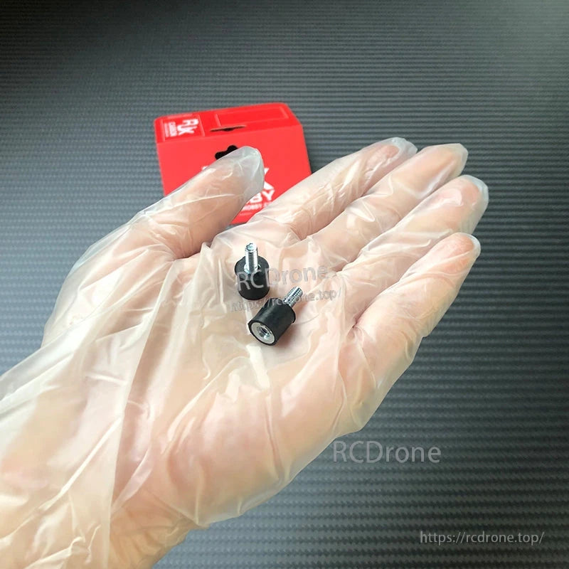 RJX 10pcs Vibration Isolator Rubber Shock Mount, Two small rubber vibration isolator shock mounts with metal threaded studs held in a gloved hand