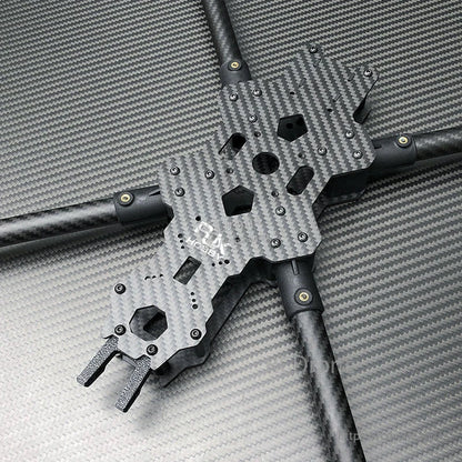 Top plate and center section of a carbon fiber FPV racing drone frame with long tubular arms and mounting holes