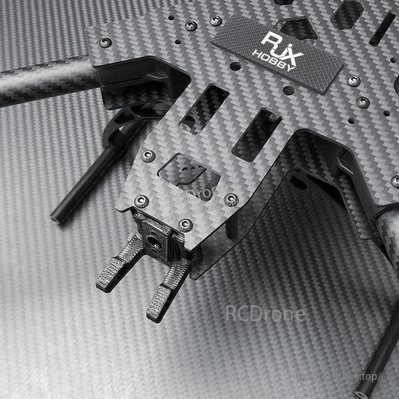 Close-up of RJX carbon fiber FPV drone frame plate with mounted landing gear and hardware