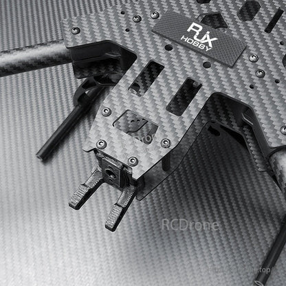 Close-up of RJX carbon fiber FPV drone frame plate with mounted landing gear and hardware