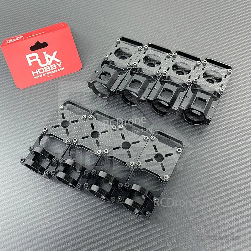 RJX Hobby aluminum alloy and carbon fiber motor mount seats for 20–25mm carbon tube quadcopter frames laid out on a carbon-textured surface