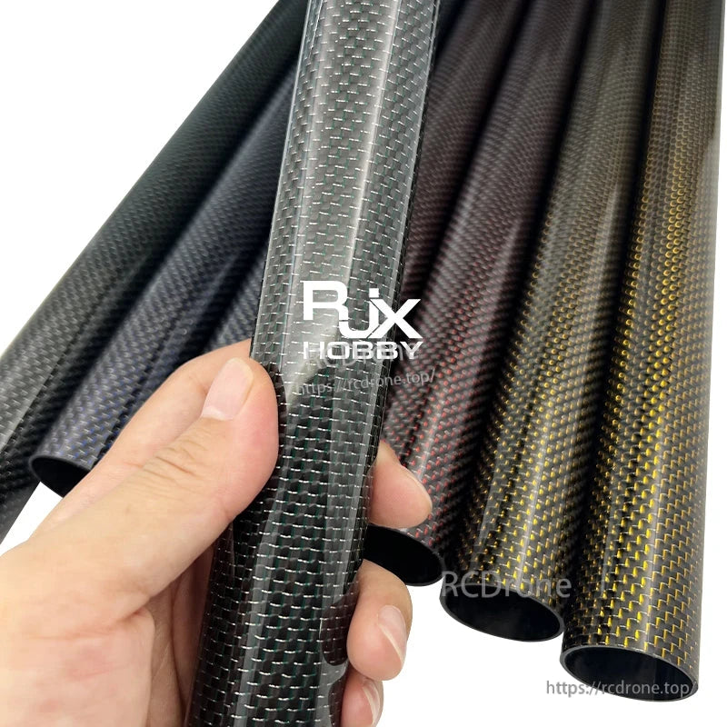 RJX 1pcs Colored 3K Carbon Fiber Tube, Hand holding a colored carbon fiber tube with woven finish, with multiple carbon fiber tubes in different colors behind