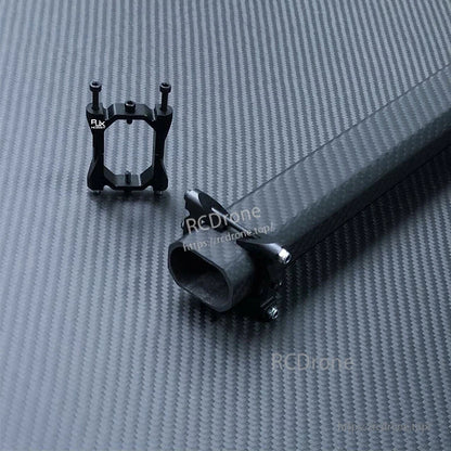 RJX 20x30mm carbon fiber octagonal tube with matching black mounting bracket on a carbon fiber surface