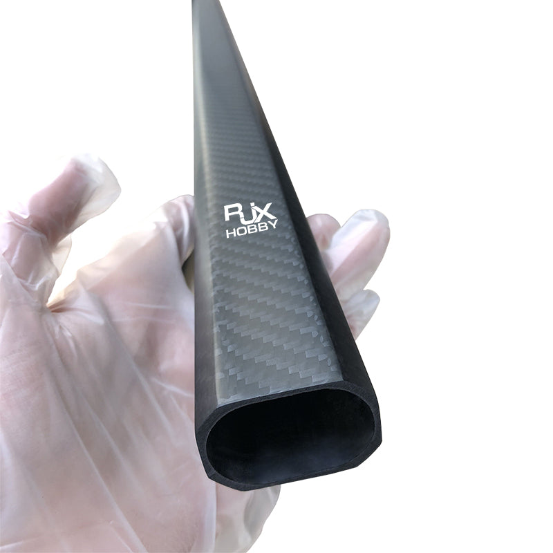RJX 25x38mm Octagonal Carbon Fiber Tube, RJX Hobby 25x38mm octagonal carbon fiber tube with matte weave finish held in a gloved hand
