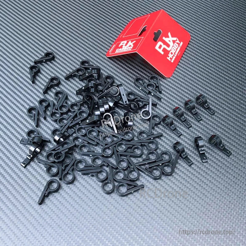 Black 9-shape tube/board connection joints for RC frames, with multiple clamp-style connectors and RX Hobby box