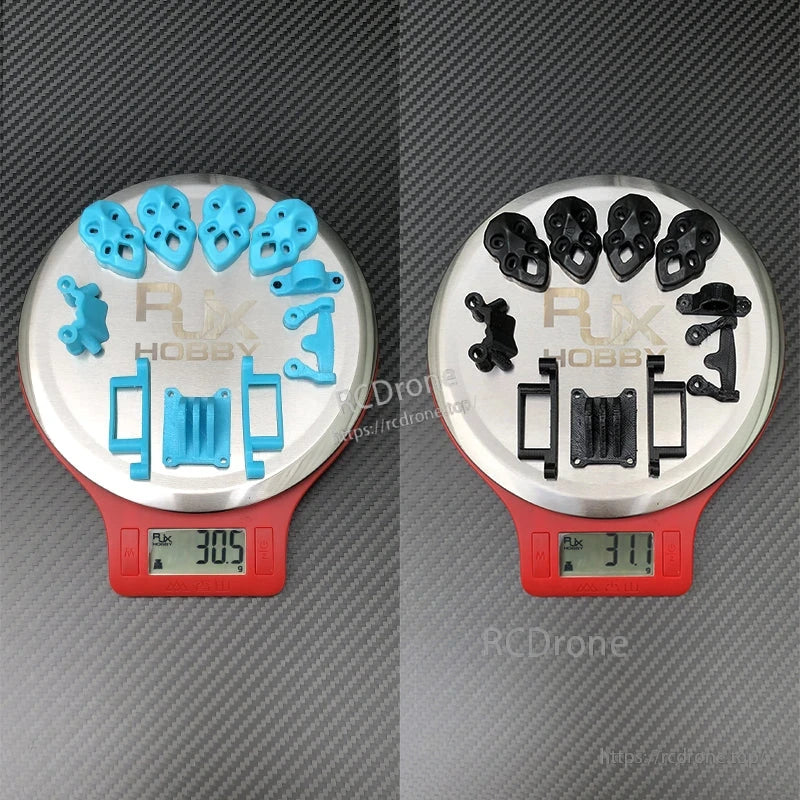 RJX 3D printed replacement parts set in blue and black on digital scales, weighing about 31g