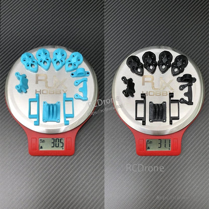 RJX 3D printed replacement parts set in blue and black on digital scales, weighing about 31g