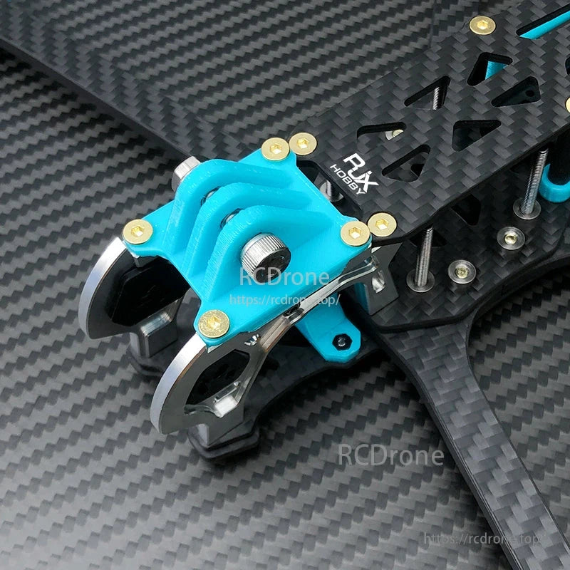 Blue 3D-printed RJX front camera mount installed on a carbon fiber FPV drone frame with metal fasteners