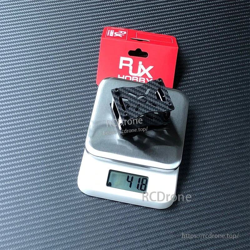 RJX Hobby carbon fiber tube clamp and motor mount bracket set on a digital scale reading 41.8