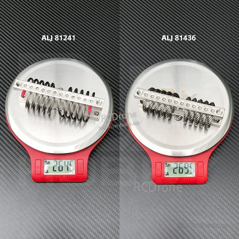 Two M5 steel wire rope vibration isolators on digital scales, labeled ALJ 81241 and ALJ 81436 at ~26g