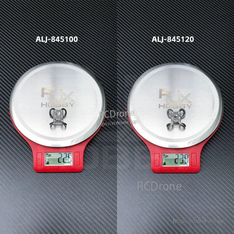 RJX Hobby steel wire rope gimbal isolator on digital scale, showing approx. 22.5g and 23.9g weights