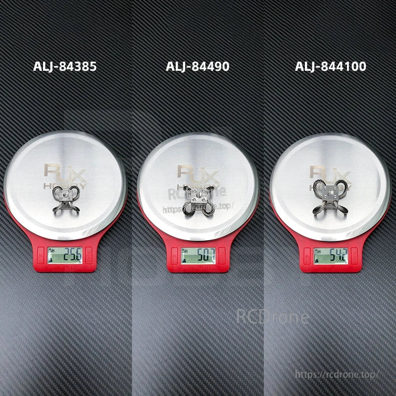 RJX steel wire rope gimbal isolators on digital scales, showing model options with weights 25.6g, 50.7g, 54.2g