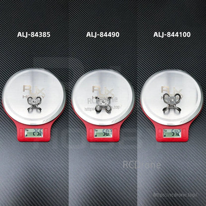 RJX steel wire rope gimbal isolators on digital scales, showing model options with weights 25.6g, 50.7g, 54.2g