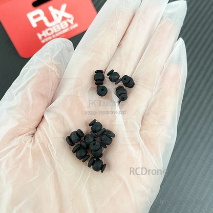 RJX 50pcs 1.5x6x8mm / 1.5x6x8.8mm Damping Ball, Hand holding small black RJX rubber damping balls for RC drones, vibration isolation grommet mounts