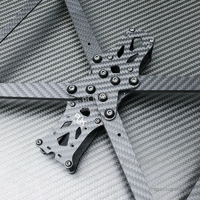RJX A1 carbon fiber FPV drone frame kit with four arms and hardware on a carbon weave background