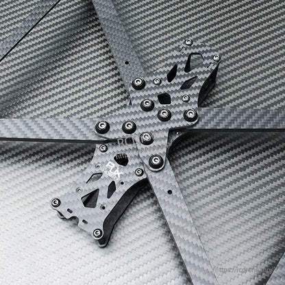 RJX A1 carbon fiber FPV drone frame kit with four arms and hardware on a carbon weave background