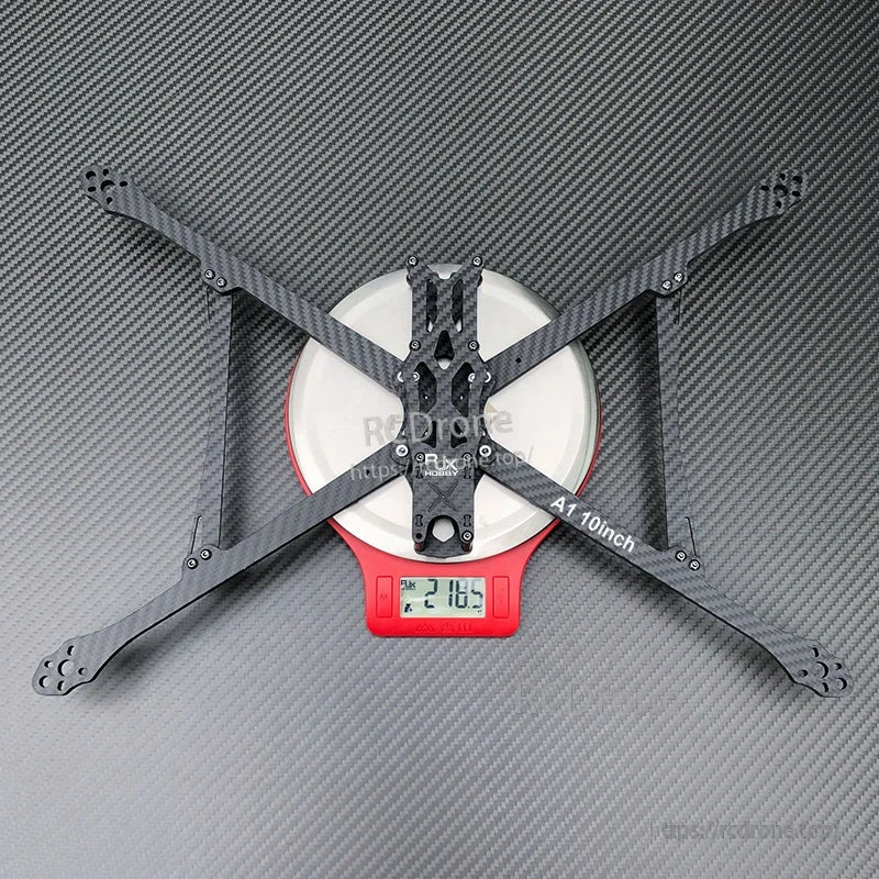 RJX A1 10-inch carbon fiber FPV racing drone frame in X layout on a digital scale reading 218.5 g