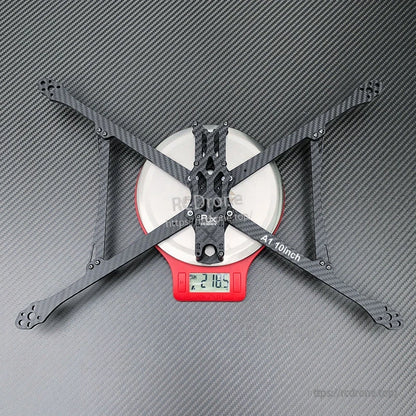 RJX A1 10-inch carbon fiber FPV racing drone frame in X layout on a digital scale reading 218.5 g