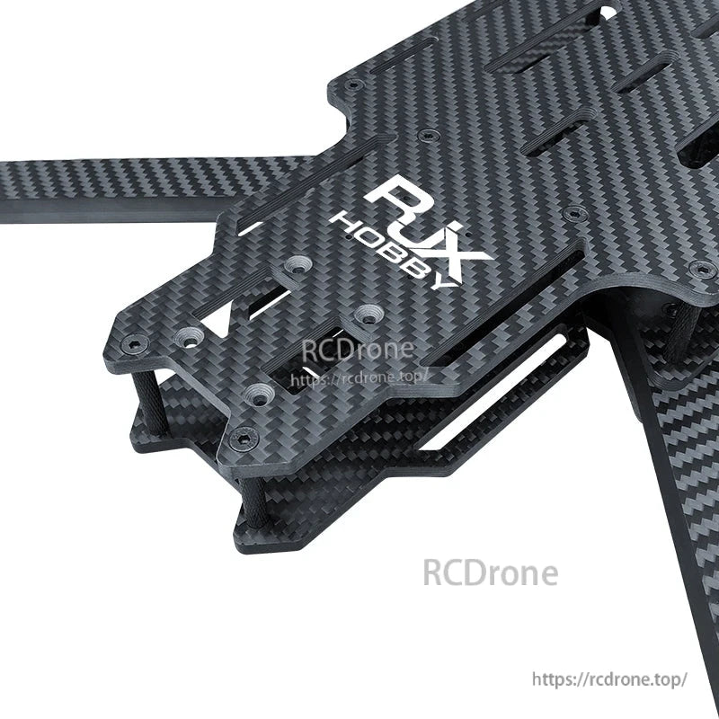 Close-up of RJX Hobby carbon fiber FPV drone frame plate with twill weave pattern, standoffs and arm mount