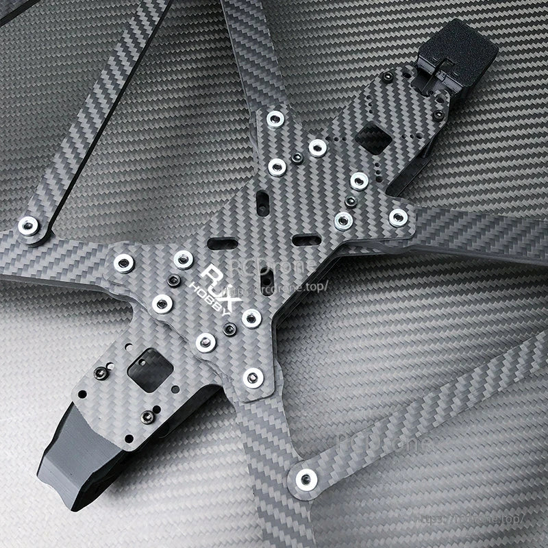 Close-up of RJX A13 carbon fiber FPV drone frame plate with RJX Hobby logo and multiple mounting holes