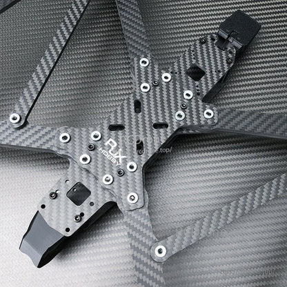 Close-up of RJX A13 carbon fiber FPV drone frame plate with RJX Hobby logo and multiple mounting holes