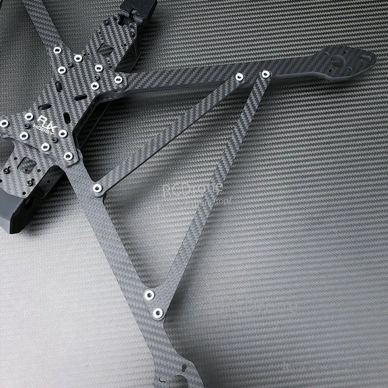 RJX A13 carbon fiber X-class FPV drone frame kit close-up with mounting holes, standoffs, and arm plates