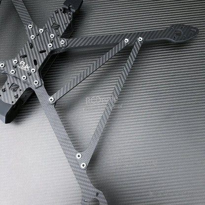 RJX A13 carbon fiber X-class FPV drone frame kit close-up with mounting holes, standoffs, and arm plates