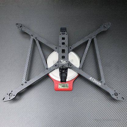 RJX A13 13-inch carbon fiber X-class FPV drone frame kit on a scale, with four wide arms and center plate