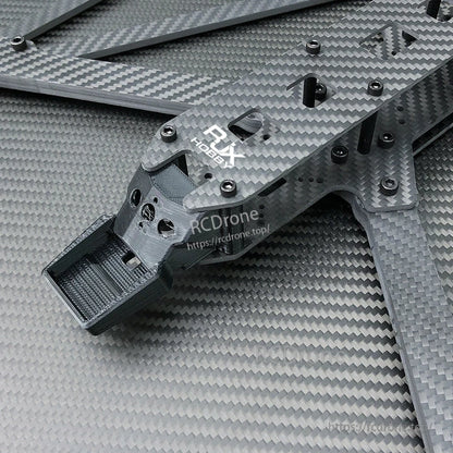 Close-up of RJX carbon fiber X-class FPV racing drone frame plate with hardware and 3D-printed mount